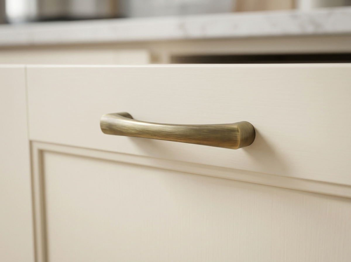 DH005 antique brass bow handle fitted to a cream in-frame drawer front