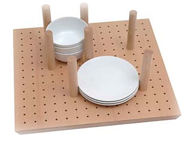 Beech peg board drawer organiser holding white plates and bowls with wooden pegs