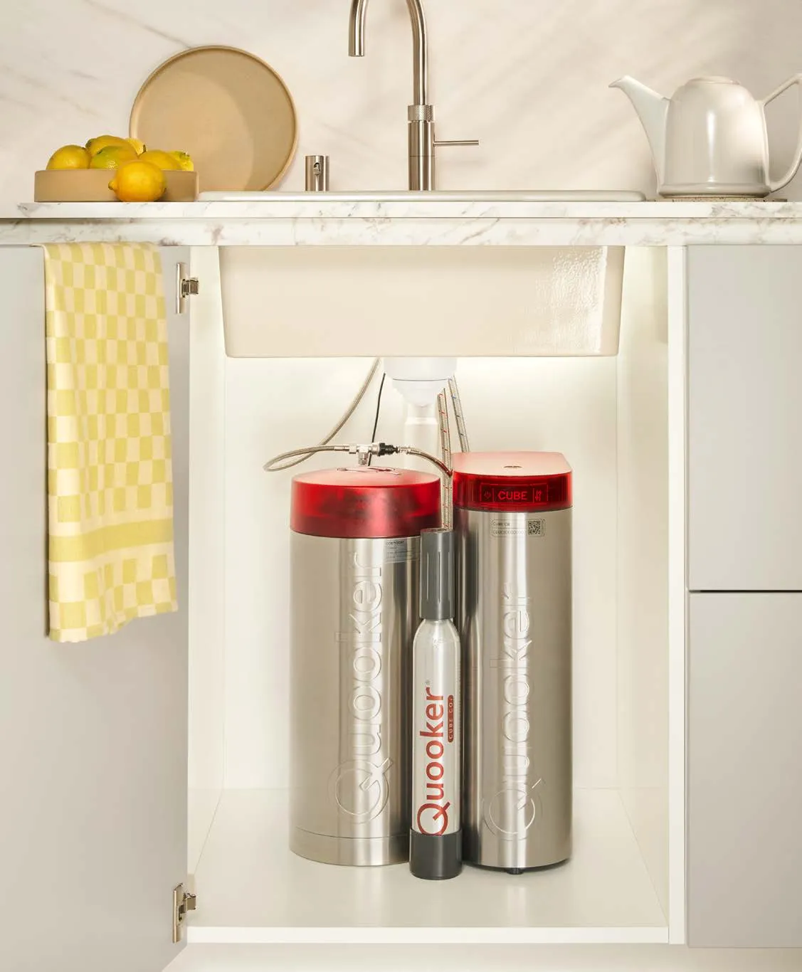 Quooker COMBI tank and CUBE with CO₂ cylinder installed in the cupboard under a kitchen sink